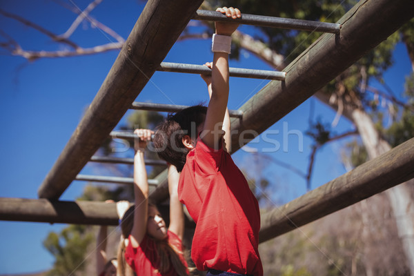 Kids climbing monkey bars during obstacle course training Stock photo © wavebreak_media