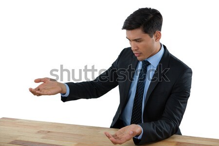 Young businessman gesturing at table during meeting Stock photo © wavebreak_media