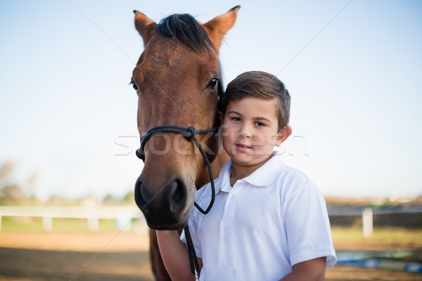 Rider boy caressing a horse in the ranch Stock photo © wavebreak_media