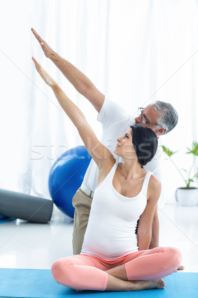 Doctor giving physiotherapy to pregnant woman Stock photo © wavebreak_media