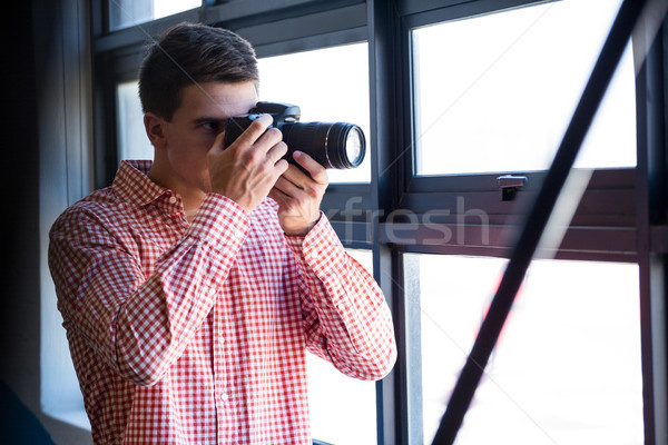Man clicking photo from camera Stock photo © wavebreak_media