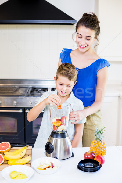 Mother assisting son to prepare juice Stock photo © wavebreak_media