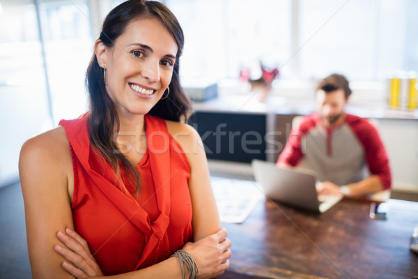 Smiling businesswoman with arms crossed Stock photo © wavebreak_media