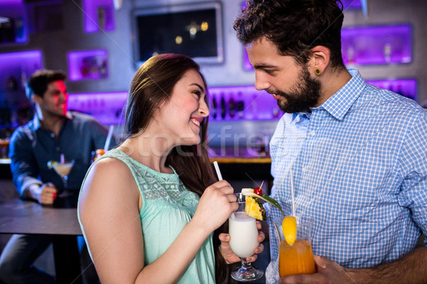 Smiling friends interacting with each other at bar counter while Stock photo © wavebreak_media
