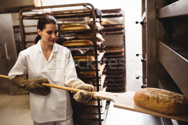 Female baker baking fresh bread Stock photo © wavebreak_media