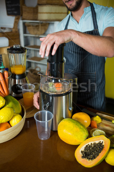 Shop assistant preparing papaya juice Stock photo © wavebreak_media
