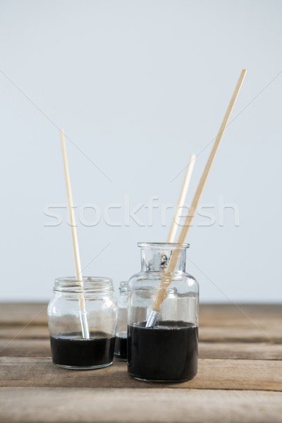 Paintbrushes with black paint dipped into water Stock photo © wavebreak_media