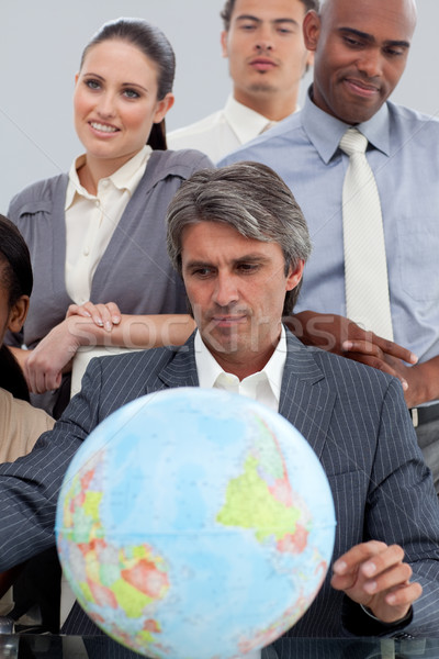 Business people around a terrestrial globe Stock photo © wavebreak_media