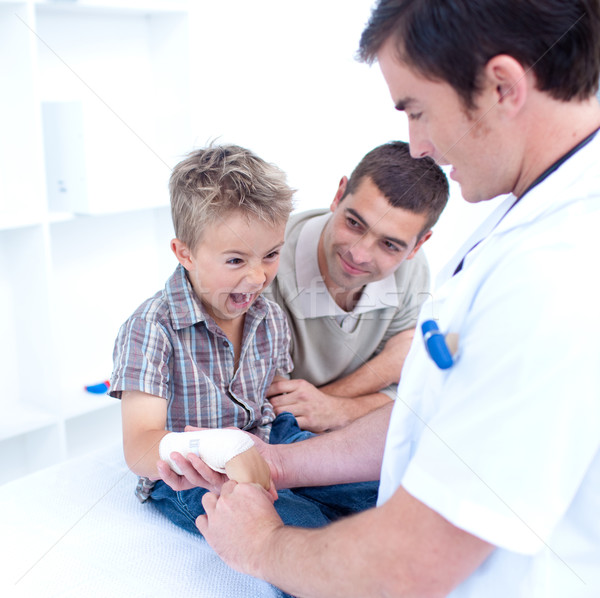 Doctor bandagins a child's arm who is yelling Stock photo © wavebreak_media