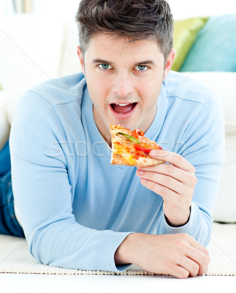 Jeune homme sol manger pizza maison santé [[stock_photo]] © wavebreak_media