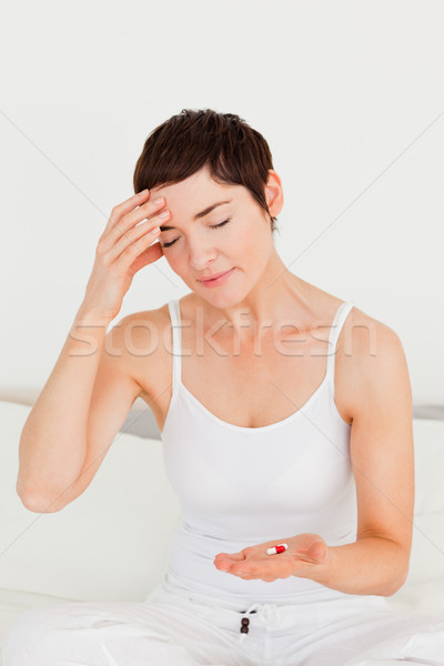 Woman having a headache in her bedroom Stock photo © wavebreak_media