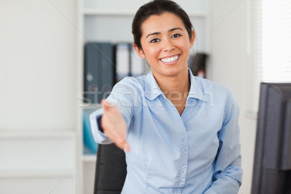 Good looking woman inviting somebody to seat while looking at the camera at the office Stock photo © wavebreak_media