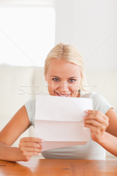 Smiling woman reading a letter in her living room Stock photo © wavebreak_media