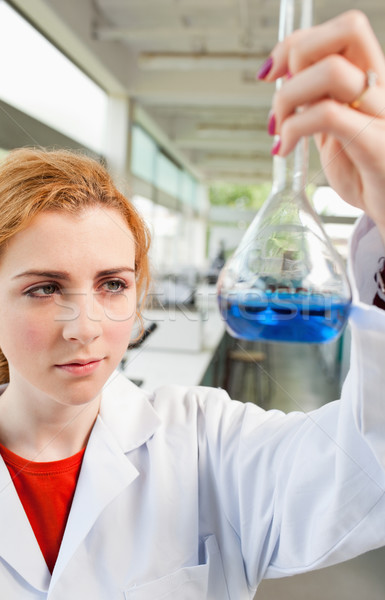 Portrait of a cute science student holding a blue liquid in a laboratory Stock photo © wavebreak_media