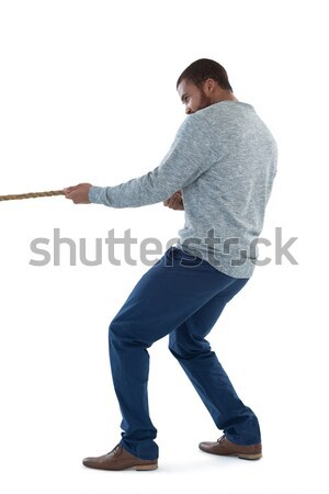 Portrait of a young businessman pushing a wall with his back against a white background Stock photo © wavebreak_media