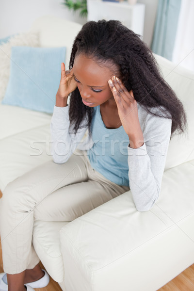 Young woman with headache sitting on sofa Stock photo © wavebreak_media