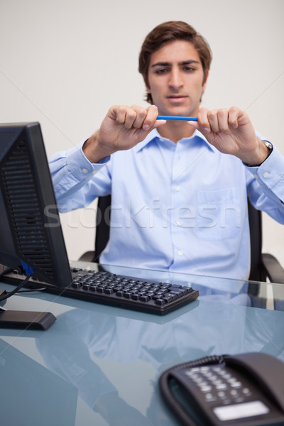 Young businessman about to break his pencil Stock photo © wavebreak_media