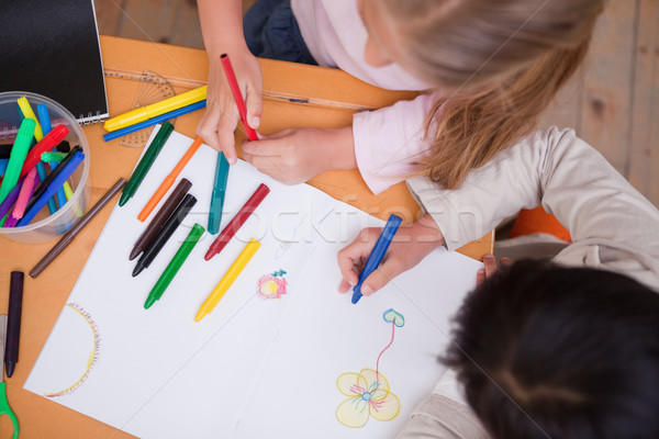 Above view of little schoolgirls drawing in a classroom Stock photo © wavebreak_media