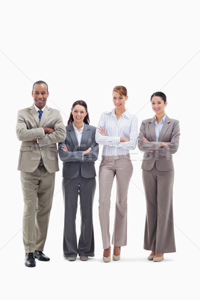 Stock photo: Business team smiling side by side and crossing their arms against white background