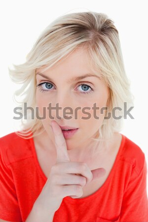 Young fair-haired woman telling to shut up with a finger on mouth Stock photo © wavebreak_media