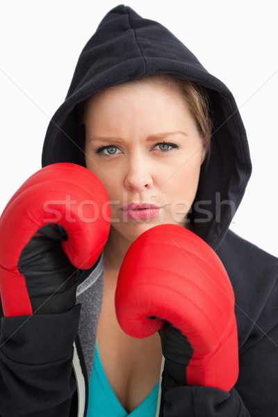 Woman showing her boxing gloves against white background Stock photo © wavebreak_media