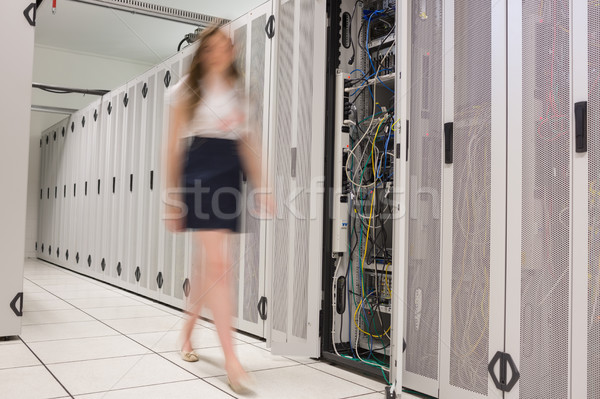 Woman walking through data center beside servers Stock photo © wavebreak_media