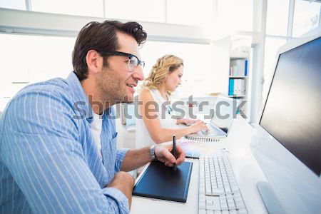 Two smiling photo editors working with contact sheets Stock photo © wavebreak_media
