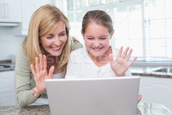 Mother and daughter talking with someone with the laptop Stock photo © wavebreak_media