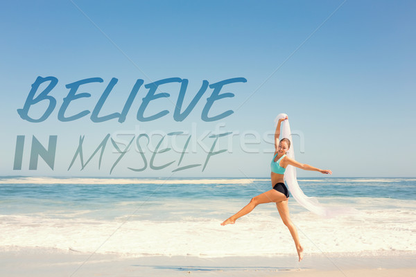 Composite image of fit woman jumping gracefully on the beach wit Stock photo © wavebreak_media