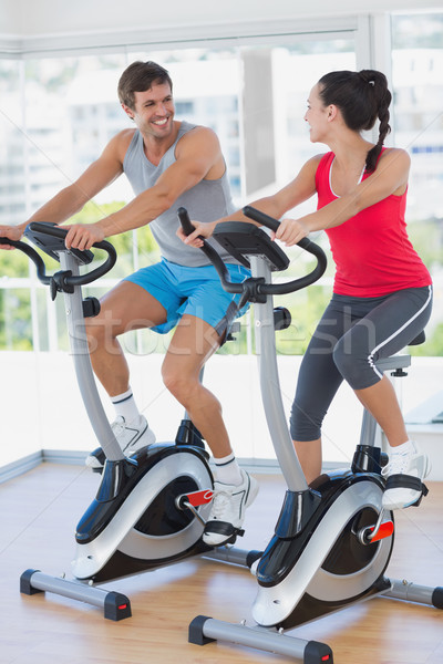 Smiling young couple working out at spinning class Stock photo © wavebreak_media