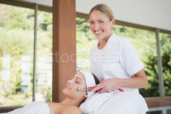 Brunette getting micro dermabrasion with therapist smiling at ca Stock photo © wavebreak_media