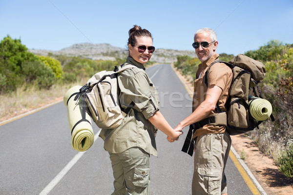 Hitch hiking couple standing holding hands on the road Stock photo © wavebreak_media