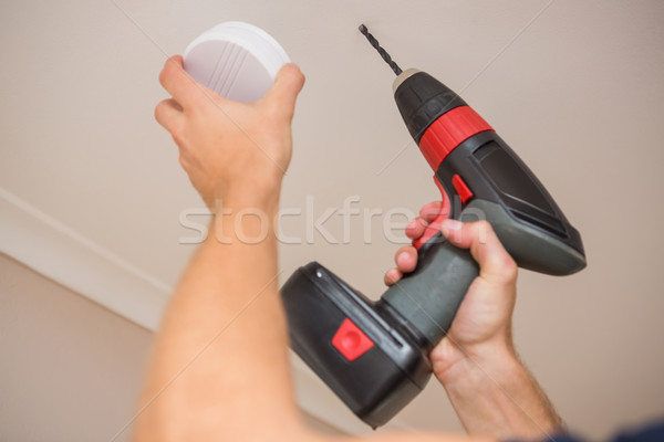 Handyman installing smoke detector Stock photo © wavebreak_media