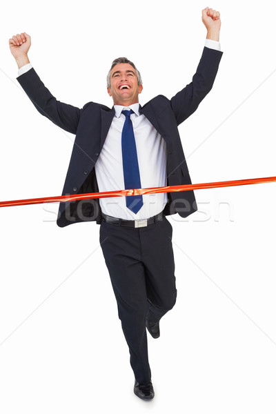 Businessman crossing finish line and cheering Stock photo © wavebreak_media