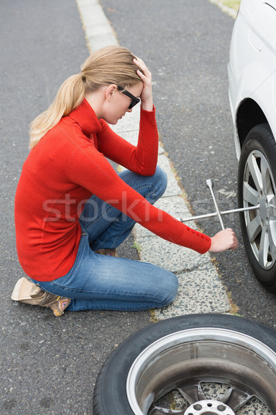 Annoyed woman trying to replace tire Stock photo © wavebreak_media