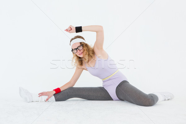 Geeky hipster stretching her legs on the floor  Stock photo © wavebreak_media