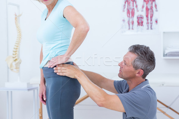 Physiotherapist examining his patient back  Stock photo © wavebreak_media