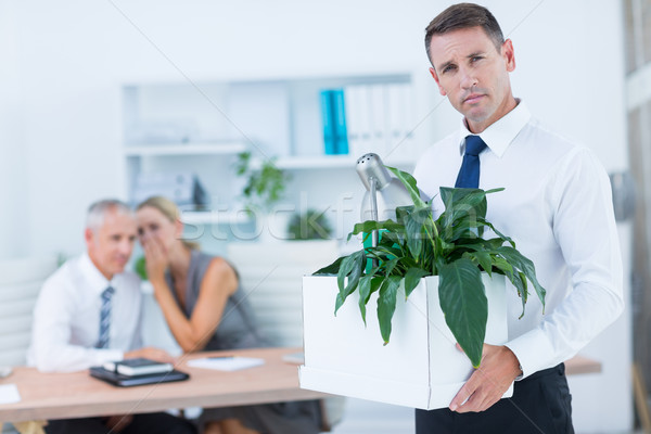 Businessman carrying his belongings with colleagues behind Stock photo © wavebreak_media