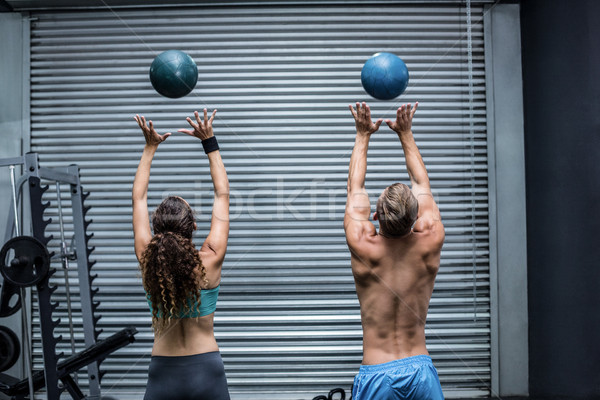 Muscular couple throwing ball in the air Stock photo © wavebreak_media