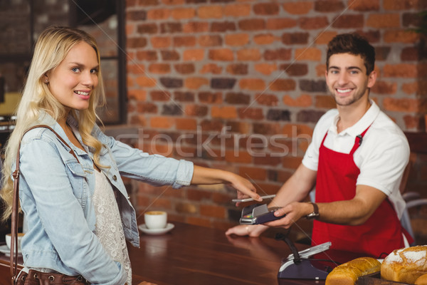 Pretty customer making a mobile payment Stock photo © wavebreak_media
