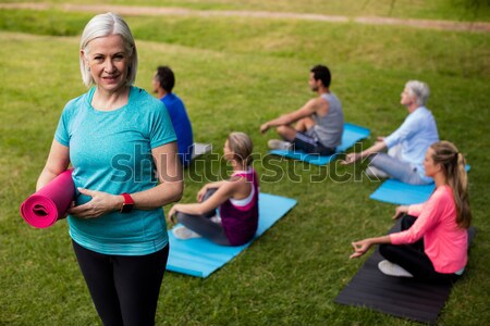 Stock photo: Female trainer writing on clipboard in the boot camp