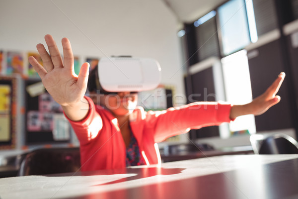 Girl gesturing while using virtual reality glasses in classroom Stock photo © wavebreak_media