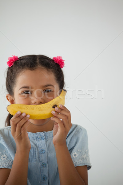 Schoolgirl having breakfast against white background Stock photo © wavebreak_media