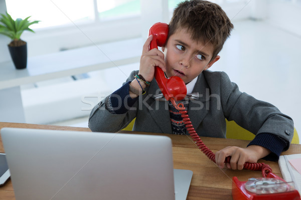 Boy as business executive talking on phone Stock photo © wavebreak_media