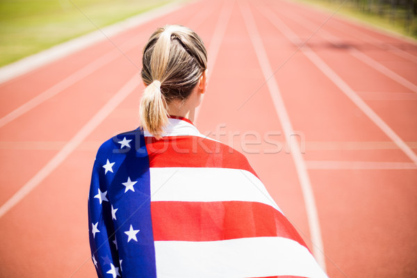 Stock photo: Rear view of female athlete wrapped in american flag