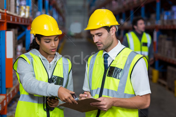 Workers looking at clipboard Stock photo © wavebreak_media