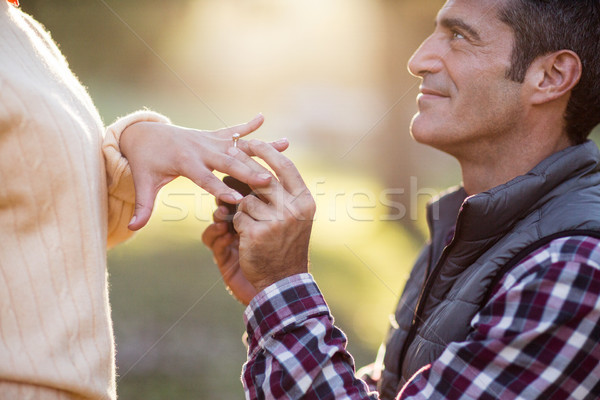 Smiling man putting ring in woman hand Stock photo © wavebreak_media