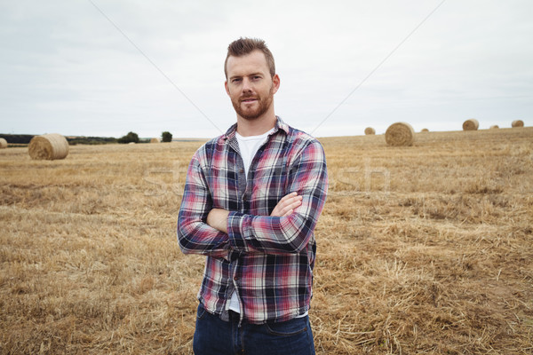 Portrait of farmer standing with arms crossed in the field Stock photo © wavebreak_media