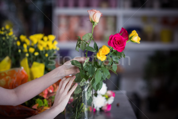 Female florist arranging flower bouquet in vase Stock photo © wavebreak_media