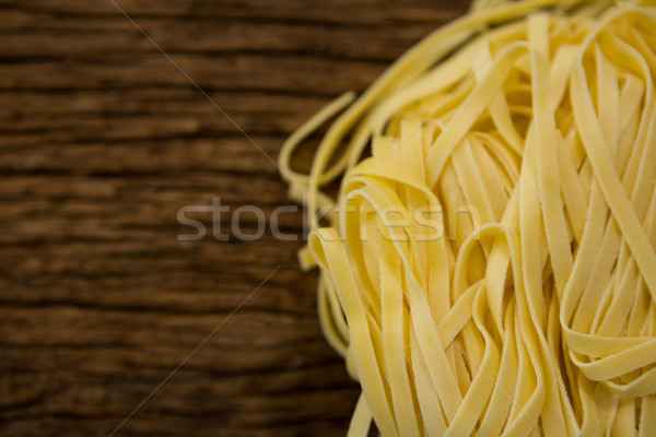 Raw tagliatelle pasta on wooden surface Stock photo © wavebreak_media